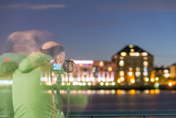 Blurred movements of photographer at night capturing city landsc