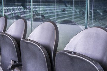 Seating rows in a stadium with weathered chairs