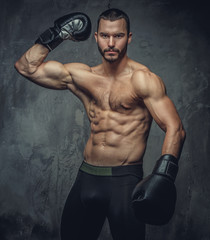 Brutal boxer fighter on grey background.