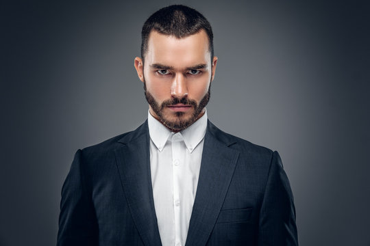 A Man In A Suit Isolated On Grey Background.