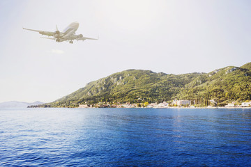 Fototapeta na wymiar The airplane is flying over the island, travel concept