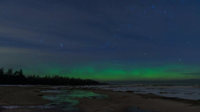 Northern lights (aurora polaris) in Ladoga lake near Saint Petersburg. Short timelapse video. Space Star Trails Timelapse. Cold winter night.