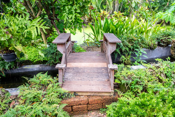 Wooden bridge and stream in garden