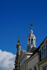 Fototapeta na wymiar old steeple in front of a blue sky