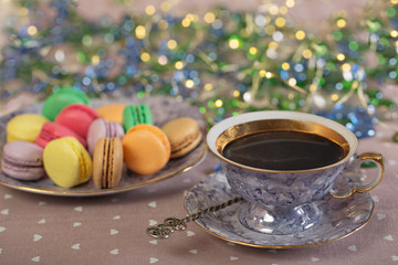 Cup of coffee with colorfull macaroons on a table