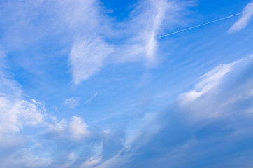 Naklejka na ściany i meble Blue sky with plane track