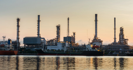 Obraz na płótnie Canvas Oil refinery industry plant. Silhouette of boat with oil refiner