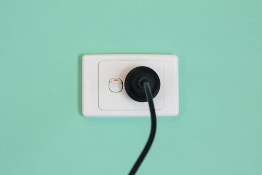 Australian electricity wall socket and plug illustrating expensive power, green energy and bill shock.