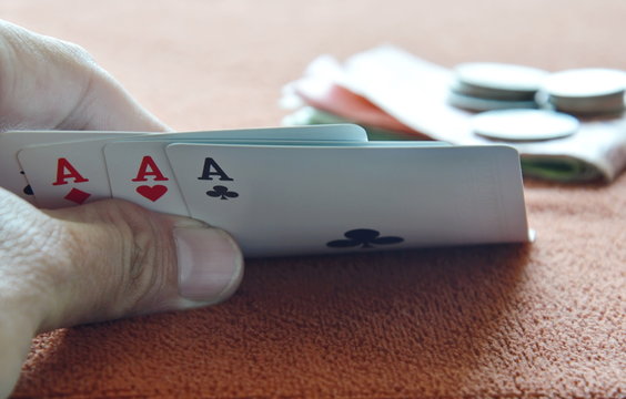 hand opened play card on table