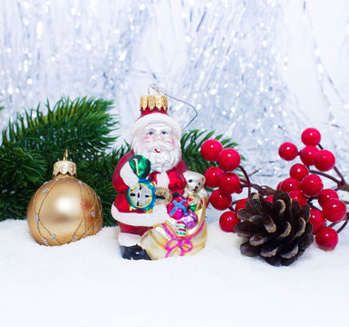 Christmas or New Year background: fur-tree, branches, gifts, colored glass balls and toy, decoration and cones on a white background with snow and sparkles