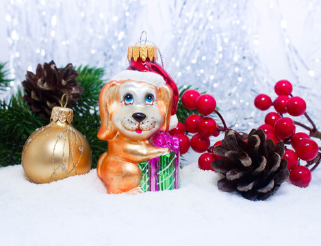 Christmas or New Year background: fur-tree, branches, gifts, colored glass balls and toy, decoration and cones on a white background with snow and sparkles