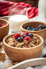 Bowl of cereals with blueberries and raspberrie.