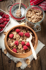 Bowl of cereals with blueberries and raspberrie.