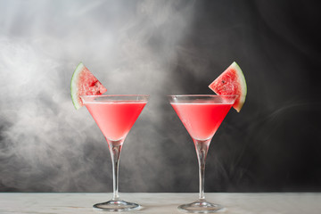 Watermelon Martini cocktail on smoke background.