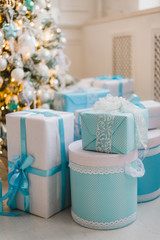 Christmas gifts under the decorated tree in blue