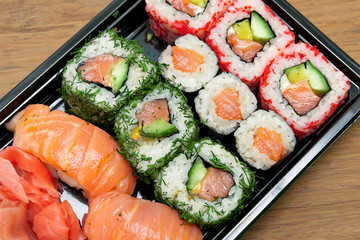 rolls and sushi on a bamboo board