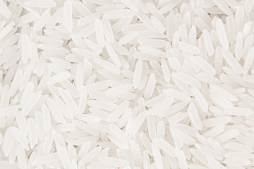 White jasmine rice close-up background. Heap polished long rice for vegetarians.