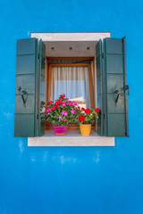 The window of brightly painted house of Burano Island. Venice. I