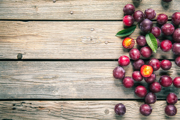fresh plums on wooden table