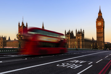 Fototapeta na wymiar London, England, UK. Red buses blured in motion on Westminster b