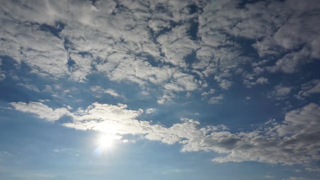 Timelapse movie of hot sun background with clouds and flare
