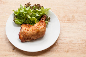 homemade grilled chicken and salad on wooden table
