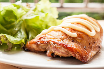 homemade grilled chicken and salad on wooden table
