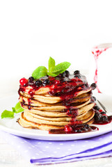 Stack of pancakes topped with berry jam