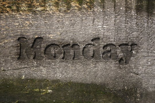 Monday carved into wood