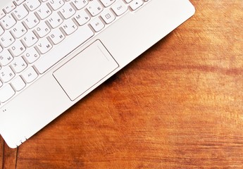 Laptop on wooden table with copy space