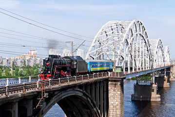 Railway bridge with retro train. Kiev, Ukraine. Kyiv, Ukraine