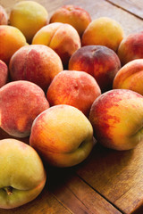 Fototapeta na wymiar Many ripe peaches on the table