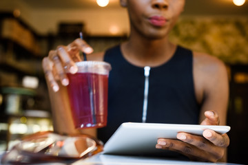 Young african business woman sitting at the cafe