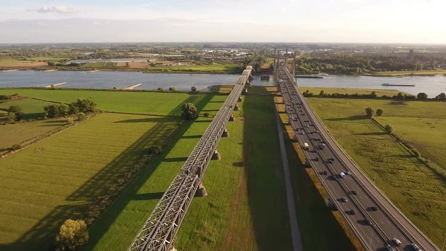 Aerial of highway and bridge with early evening traffic over river 'Waal' in Holland.