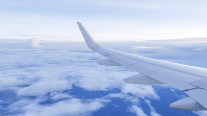Wing of airplane fly over  the blue sky and white cloud 1