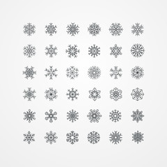 Fototapeta na wymiar Collection of black snowflakes on a white background
