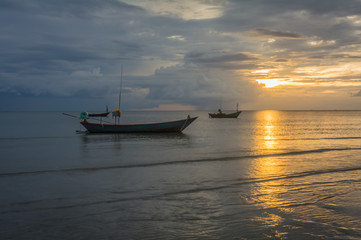 Fishing boats in the sea and a beautiful sky while the sunset,  Chao Lao Beach,  Chanthaburi, Thailand.