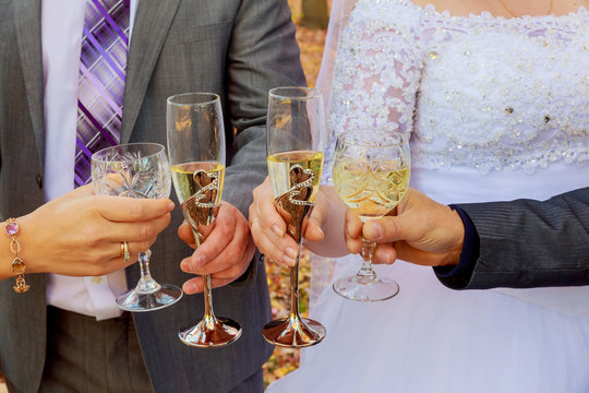 Bride and bridesmaids celebrate  drink champagne from glasses