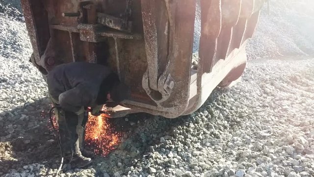 Russian worker cuts metal welding