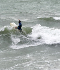 a surfer surf a wave in italy