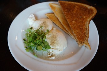 English breakfast of poached eggs and brown toast
