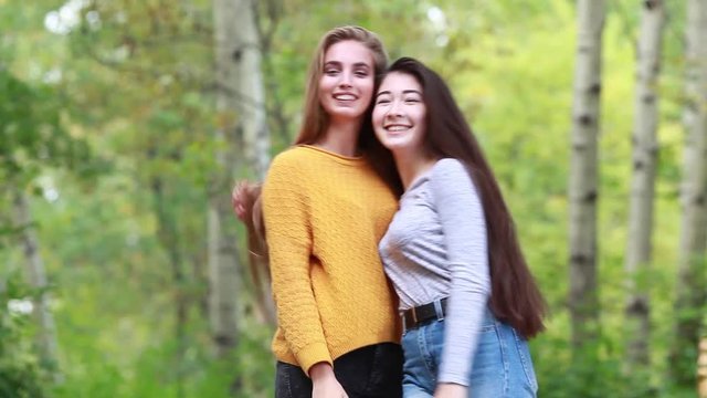 Two beautiful girl with long hair plush in nature