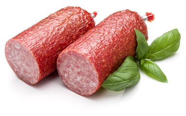 Salami smoked sausage and basil leaves isolated on white backgro