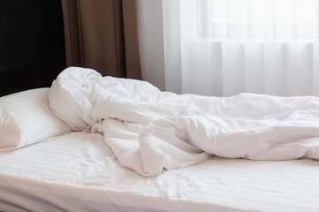 White themed bed sheets bedroom interior.