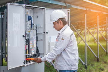 engineer or electrician working on  maintenance equipment at industry solar power