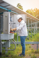 engineer or electrician working on  maintenance equipment at industry solar power