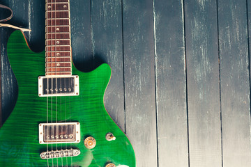 Obraz premium Electric guitar body and neck detail on wooden background