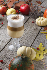 Pumpkin spice latte. Coffee cup on white wood background