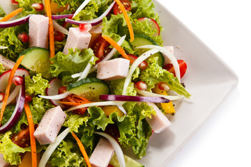 Ham and vegetables on white background