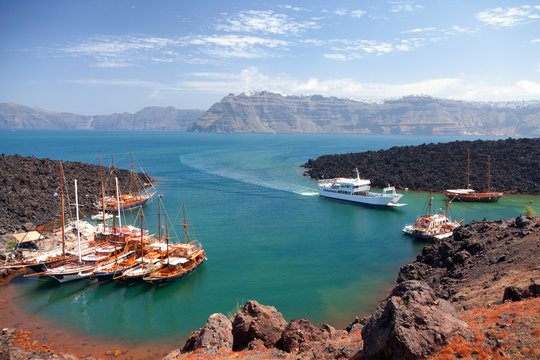 Nea Kameni volcanic island in Santorini, Greece. Ships from Fira